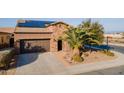 Aerial view of a home featuring a landscaped yard, two-car garage, and installed solar panels at 1808 E Crocus Ave, Queen Creek, AZ 85140