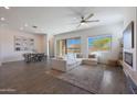 Open-concept living room with dining area, fireplace, and a view of the backyard pool at 18509 W Galveston St, Goodyear, AZ 85338