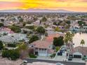Aerial view showcasing a lakefront home and surrounding neighborhood at sunset at 21004 N 53Rd Ave, Glendale, AZ 85308