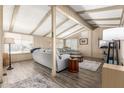 Cozy living room featuring wood floors, exposed beams, and comfortable furniture at 211 S 54Th Pl, Mesa, AZ 85206