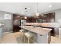 Modern kitchen with stainless steel appliances, granite countertops, and a center island with bar stool seating at 3833 E Stiles Ln, Gilbert, AZ 85295