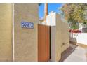 Private courtyard entry with wooden gate and stucco exterior at 5018 E Siesta Dr # 3, Phoenix, AZ 85044