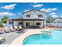 Inviting backyard features a sparkling pool, spa, covered patio with ample seating, and outdoor kitchen with BBQ grill at 5101 E Winchcomb Dr, Scottsdale, AZ 85254