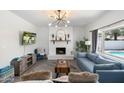 Bright living room with a brick fireplace, modern lighting, and comfortable seating offers a relaxing atmosphere at 5101 E Winchcomb Dr, Scottsdale, AZ 85254