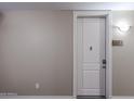Apartment front door with unit number, detailed trim, modern lock, and neutral-colored walls at 5450 E Deer Valley Dr # 2193, Phoenix, AZ 85054