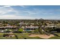 Stunning aerial view of a luxury home with pool, golf course, and city skyline at 6302 E Hillcrest Blvd, Scottsdale, AZ 85251