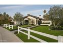 Attractive home exterior featuring a manicured lawn, walkway, and white picket fence, creating a welcoming ambiance at 6531 N 81St Pl, Scottsdale, AZ 85250