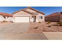 Well-maintained single-story home with a two-car garage, tile roof, and desert landscaping at 8134 E Obispo Ave, Mesa, AZ 85212