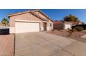 Single-story home with a two-car garage, low maintenance desert landscaping, and tile roof at 8134 E Obispo Ave, Mesa, AZ 85212