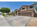 Beautiful home with a spacious driveway and two-car garage, perfect for a growing Gathering at 8534 W Salter Dr, Peoria, AZ 85382