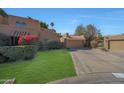 Charming front exterior with a well-maintained lawn, brick-lined driveway, and a two-car garage at 10648 N 11Th St, Phoenix, AZ 85020