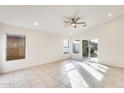 Bright, airy room with tile flooring, ceiling fan, and sliding glass door to the backyard at 11825 W Flanagan St, Avondale, AZ 85323