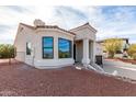 A bright, stucco house with a tile roof and desert landscaping offers curb appeal and low maintenance at 15541 E Thistle Dr, Fountain Hills, AZ 85268