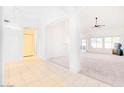 Bright, open-concept living area with tile flooring, neutral carpeting, and ample natural light at 1612 E South Mountain Ave, Phoenix, AZ 85042