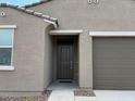 Close up view of the front entrance featuring a dark door and matching hardware at 17449 W Eva St, Waddell, AZ 85355