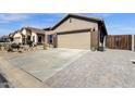 Long driveway leading to a two car garage with desert landscaping in front at 18434 E El Buho Pequeno Rd, Gold Canyon, AZ 85118