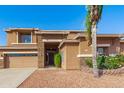 Inviting home with stone accents, desert landscaping, and mature trees, creating curb appeal at 1870 E Indigo Dr, Chandler, AZ 85286