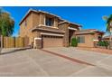 Spacious two-story home with a wide driveway, three-car garage, and desert landscaping at 1870 E Indigo Dr, Chandler, AZ 85286