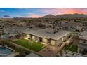 Expansive backyard with lush green turf, recreational amenities, and a pool area, perfect for outdoor entertainment at 19726 E Vallejo St, Queen Creek, AZ 85142