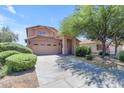 Charming two-story home with desert landscaping, attached two-car garage, and a large shade tree at 2635 W Angel Way, San Tan Valley, AZ 85144
