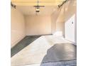 A single car garage featuring concrete floors, overhead lighting, and an automatic door opener at 295 N Rural Rd # 259, Chandler, AZ 85226