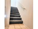 Carpeted stairway with white walls and handrail that leads to the upper level of the home at 295 N Rural Rd # 259, Chandler, AZ 85226