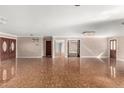 Expansive living room featuring ceramic tile flooring, neutral walls, and recessed lighting at 3135 W Echo Ln, Phoenix, AZ 85051