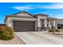 Attractive one-story home showcasing neutral stucco, stone accents, and a spacious driveway at 4051 S 243Rd Dr, Buckeye, AZ 85326