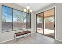 Cozy dining area with large windows providing ample natural light and access to the outdoor patio at 41309 N Belfair Way, Anthem, AZ 85086