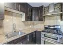 Close up shot of kitchen with stainless steel oven and decorative tile backsplash at 4950 N Miller Rd # 135, Scottsdale, AZ 85251