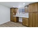 Walk-in pantry with custom cabinets and marble countertops, offering ample storage space at 5738 E Cicero Rd, Mesa, AZ 85205