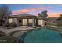 Inviting backyard featuring a sparkling pool, covered patio, and lush greenery, ideal for outdoor relaxation at 7619 E Elderberry Way, Gold Canyon, AZ 85118