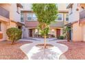 Landscaped courtyard with pavers and desert plants between townhomes at 7807 W Palm Ln, Phoenix, AZ 85035