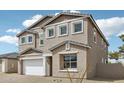 Charming two-story home features a stucco exterior, a two-car garage, and a well-maintained lawn at 9522 W Luxton Ln, Tolleson, AZ 85353