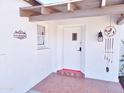 Covered porch with decorative tile flooring and a unique wind chime at 1541 W Culver St, Phoenix, AZ 85007