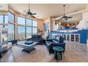 Open-concept living room with a fireplace, expansive windows, and mountain views at 16141 E Thistle Dr, Fountain Hills, AZ 85268