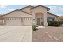 Beige single-story home featuring a two-car garage, desert landscaping, and a cozy front entryway at 20626 N 55Th Ave, Glendale, AZ 85308
