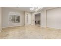 Bright and airy living room featuring travertine floors and large windows at 27250 N 86Th Ave, Peoria, AZ 85383