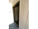 Close-up of front door with number and peephole, set within a textured wall at 2938 N 61St Pl # 234, Scottsdale, AZ 85251