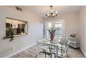 Cozy dining area featuring a stylish chandelier and seating for four with natural light at 4525 E Rhonda Dr, Phoenix, AZ 85018