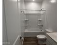 Clean bathroom featuring a tub and shower, a vanity with a sink and a toilet at 9525 W Luxton Ln, Tolleson, AZ 85353
