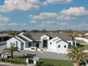 Stunning single-story home with white stucco, a gray roof, and a meticulously landscaped front yard at 12218 N 104Th St, Scottsdale, AZ 85260