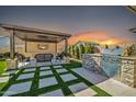 Backyard oasis featuring an outdoor kitchen, bar, and tv for entertaining and relaxation at 1957 W Lonesome Trl, Phoenix, AZ 85085