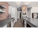 Contemporary kitchen featuring stainless steel appliances, a brick backsplash, and concrete floors at 207 W Clarendon Ave # B22, Phoenix, AZ 85013