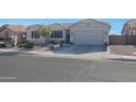 Inviting single-story home with desert landscaping, a paved driveway, and a neutral color scheme at 22805 W Hopi St, Buckeye, AZ 85326