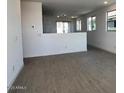 Open-concept living room with tile flooring and abundant natural light at 23252 W Miami St, Buckeye, AZ 85326