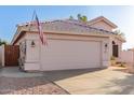 Exterior view showcasing the home's garage and desert-style front yard at 3403 E Kristal Way, Phoenix, AZ 85050