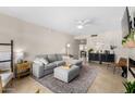 Inviting living room with a gray sofa, neutral walls and lots of natural light at 406 W Riviera Dr, Tempe, AZ 85282