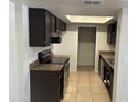 Well-lit kitchen featuring brown cabinets, countertops, and appliances, complemented by tiled flooring at 4424 E Pueblo Ave, Phoenix, AZ 85040