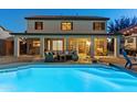 Inviting backyard with a sparkling pool, covered patio, and comfortable outdoor seating area at 586 E Stirrup Ln, San Tan Valley, AZ 85143